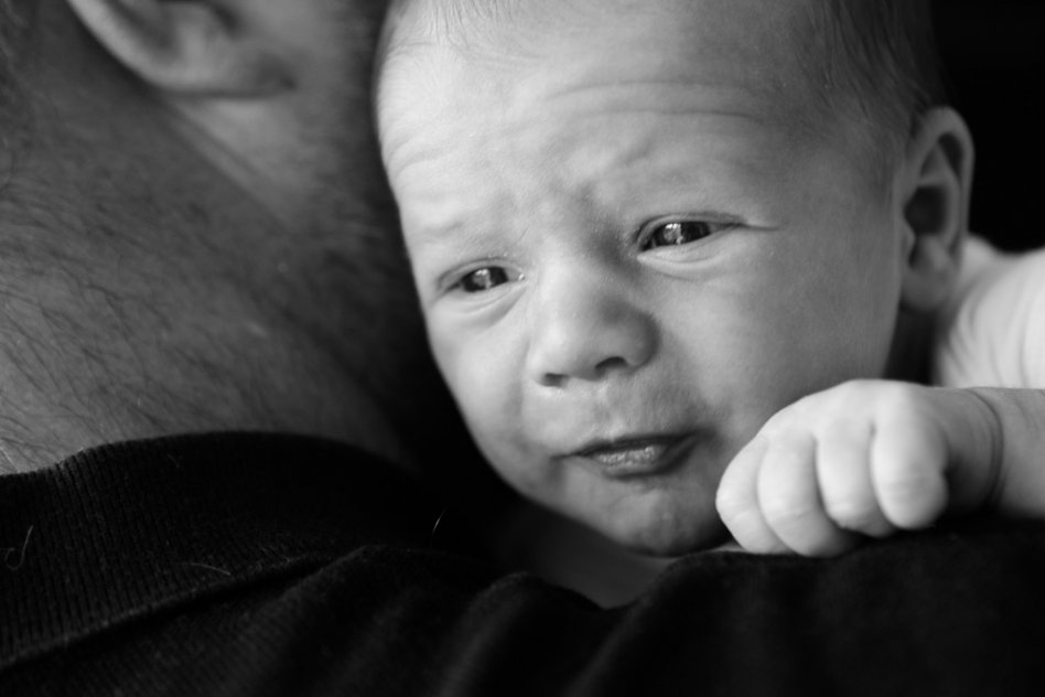 black and white portrait of newborn baby with father