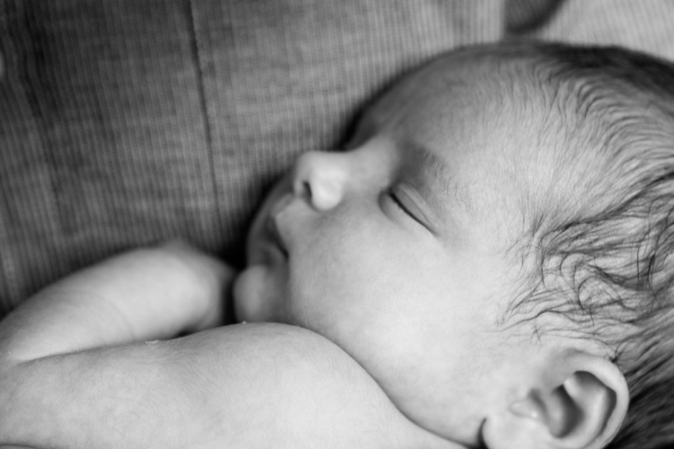 black and white portrait of newborn baby with father